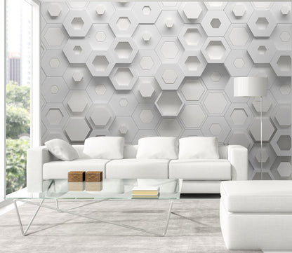 Modern living room with white hexagonal wall panels and a glass coffee table.