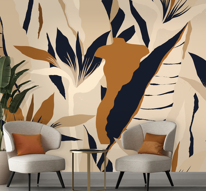 Two gray chairs with orange cushions in front of a wall with abstract leaf pattern