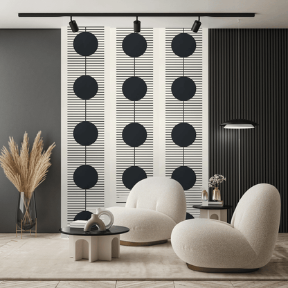 Modern living room with white armchairs, a black coffee table, and decorative wall art.