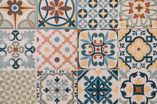 Patterned tiles with various geometric and floral designs in a grid layout.
