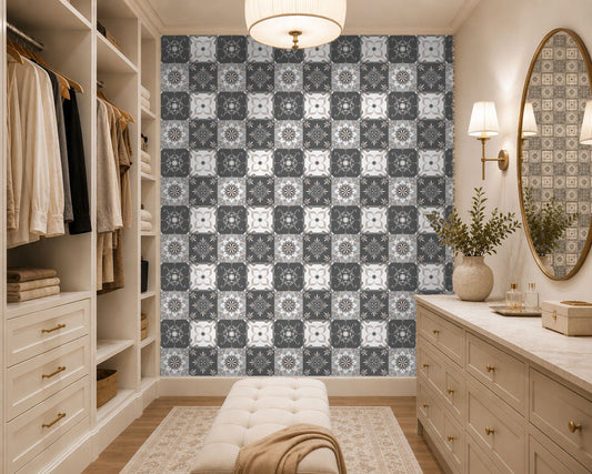 Modern walk-in closet with patterned wallpaper, dressers, and a mirror.