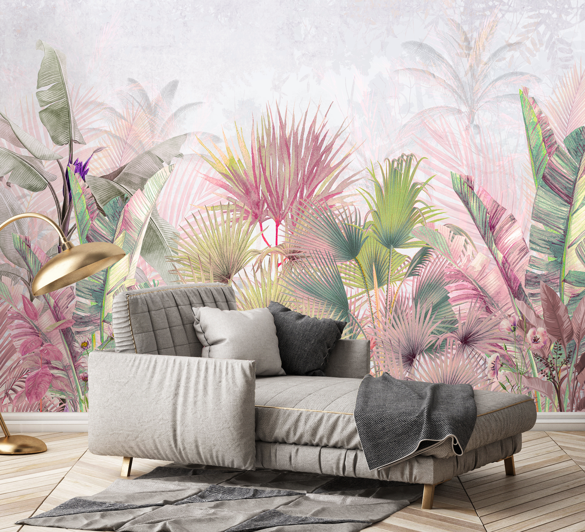 Gray sofa with decorative pillows against a colorful tropical leaf wallpaper.