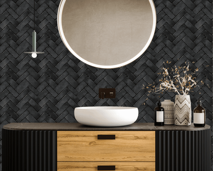 Bathroom with wooden vanity, white sink, and decorative items against a black woven wall.