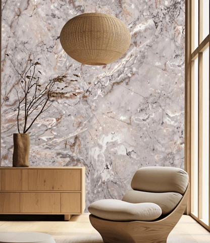 Modern interior with a beige armchair, wooden cabinet, and woven pendant light against a marble wall.