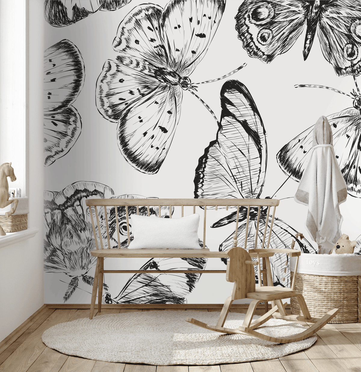 Nursery room with butterfly wallpaper, wooden crib, and rocking horse.